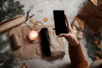 Cropped hands of woman using mobile phone