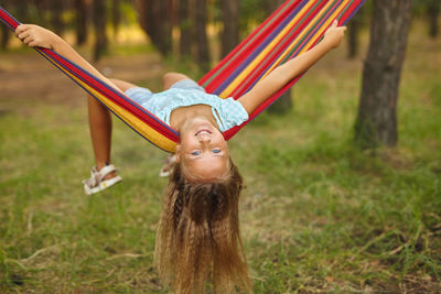 Portrait of girl lying on hammock