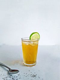 Close-up of drink on table against white background