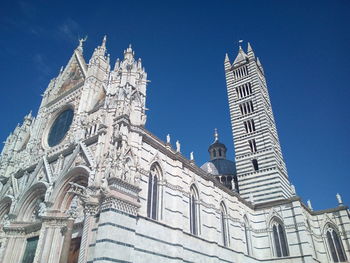 Low angle view of church against clear blue sky