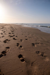 Footprints on a sandy ocean beach