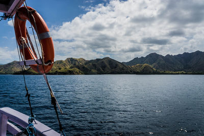 Sailboat in lake against sky