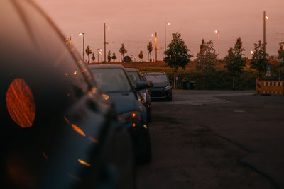 Traffic on road at sunset