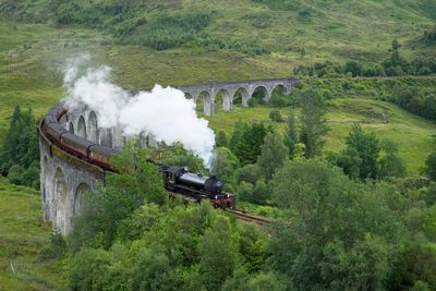 High angle view of steam train on bridge 