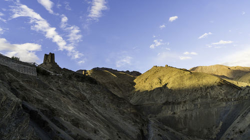 Low angle view of rocky mountains against sky
