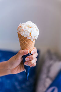 Cropped hand holding ice cream cone