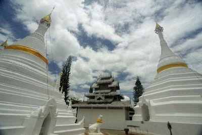 Low angle view of pagoda against cloudy sky