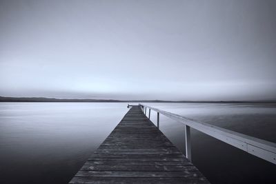 Pier over sea against clear sky