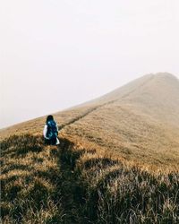 Woman walking on track on mountain