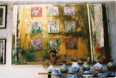 Full length of man sitting by window