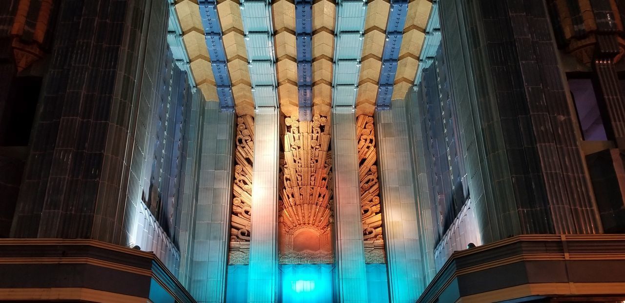 LOW ANGLE VIEW OF ILLUMINATED GLASS BUILDING