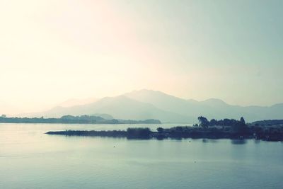 Scenic view of lake against sky at sunset