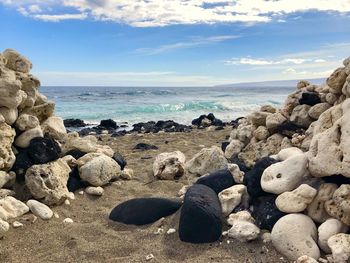 Rocks on beach against sky