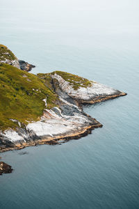 High angle view of synergy between rocky cliffs and the sea. ideal for nature and coastal projects. 