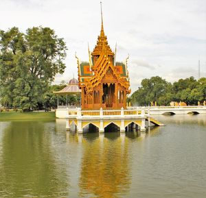 View of bridge over river against cloudy sky