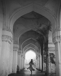 Woman walking in tunnel