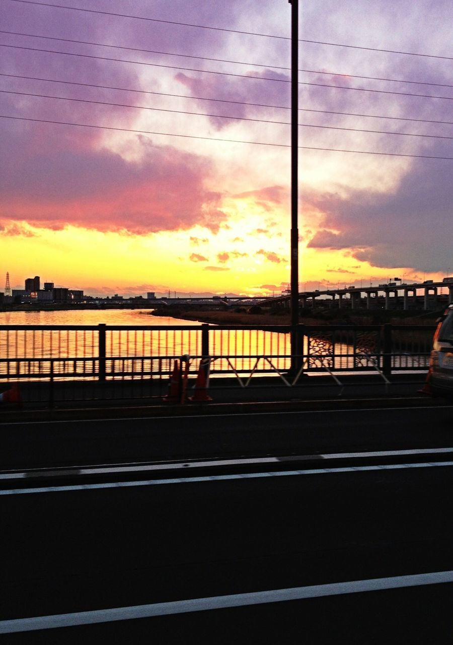 sunset, sky, cloud - sky, architecture, built structure, silhouette, street light, building exterior, cloud, railing, city, orange color, bird, dusk, connection, bridge - man made structure, cloudy, water, outdoors, nature