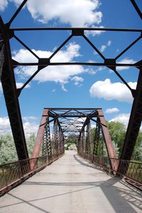 View of footbridge against cloudy sky