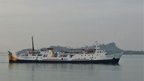 Ship sailing on sea against clear sky