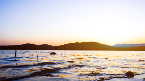 Scenic view of sea against clear sky during sunset