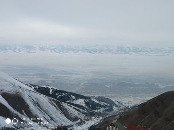 Aerial view of snowcapped mountains against sky