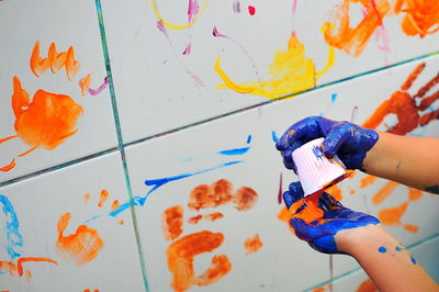 Close-up of hand painting wall