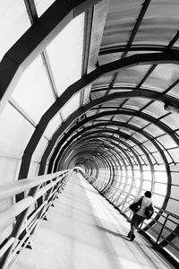 Full length of woman walking on escalator