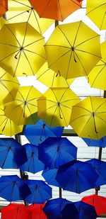 Low angle view of umbrellas hanging against ceiling