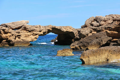 The natural arch of cala birìala in the gulf of orosei in sardinia.