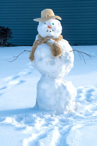 Snowman on snow covered field