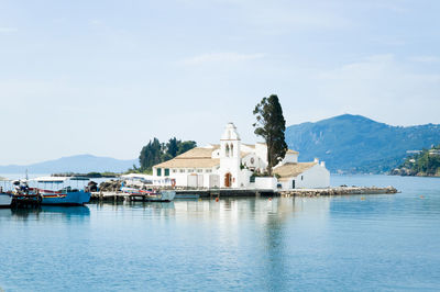Boats in river with buildings in background