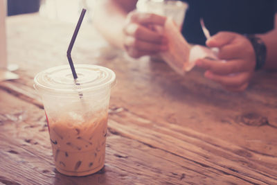 Iced cappuccino on wooden table.iced coffee in a plastic cup.