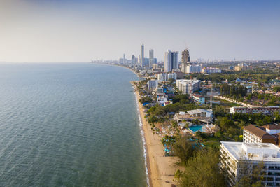 High angle view of buildings and sea against sky