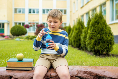 Portrait of boy sitting outdoors
