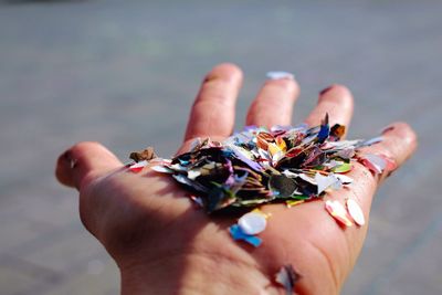 Cropped image of hand holding confetti