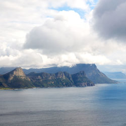 Scenic view of sea and mountains against sky