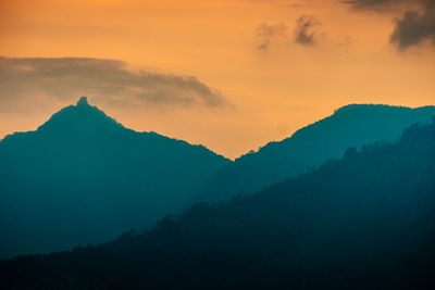 Scenic view of silhouette mountains against sky at sunset