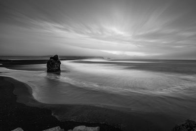 A black and white long exposure shot of reynisfjara beach, iceland