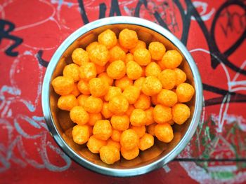 Directly above shot of cheese balls in bowl on table