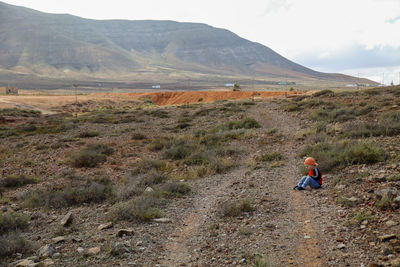 Rear view of man walking on mountain