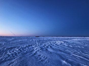 Scenic view of frozen sea against clear blue sky