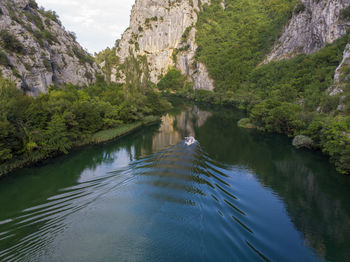 Scenic view of river by mountains