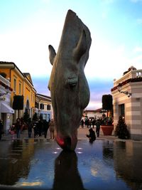 Statue of people in front of building