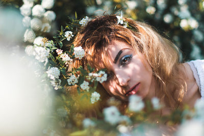 Portrait of young woman with flowers