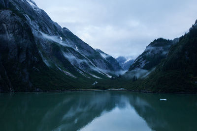 Scenic view of lake and mountains against sky