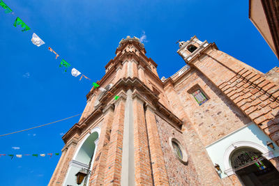 Low angle view of traditional building against blue sky