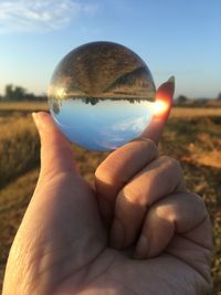 Close-up of hand holding crystal ball