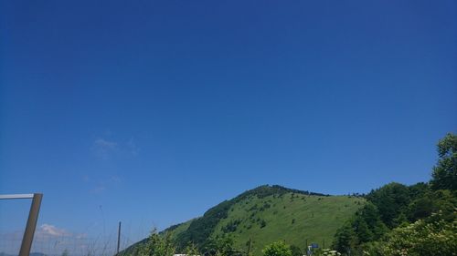 Low angle view of mountain against clear blue sky