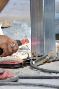 Close-up of man working on metal