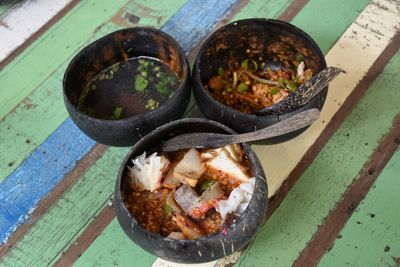 Using a spoon and bowl made of coconut shell. ayutthaya province.